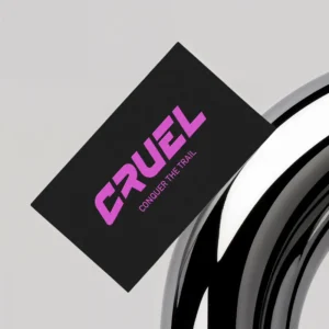 Business card mockup showing front side with Cruel Components purple logo textured print on a black background
